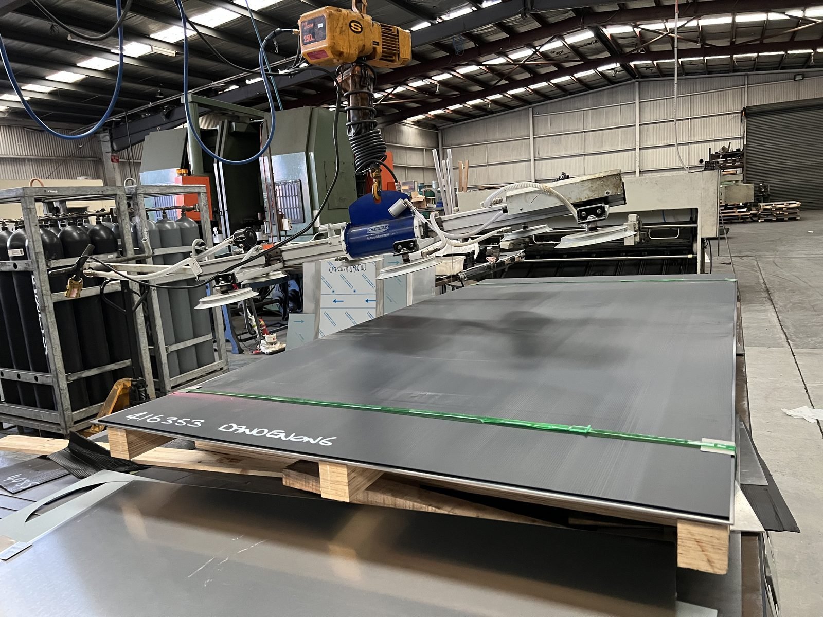 Sheet metal being loaded onto the fibre laser cutter